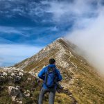 West Balkans hiking - man in blue jacket and gray pants hiking