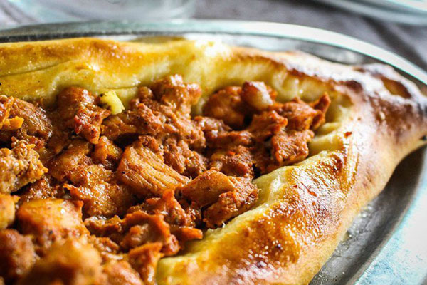 Pastrmajlija (North Macedonia)  – Oval bread topped with salted meat.