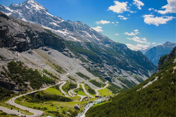 Stelvio Pass (Lombardy, Italian Alps): Start from Bormio, ride 48 hairpin turns with dramatic elevation and charming Alpine villages.