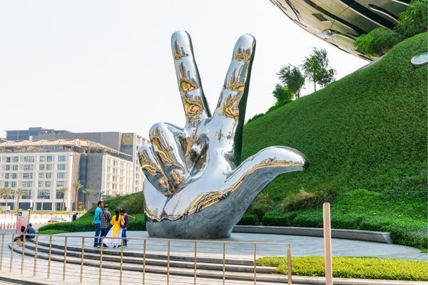 Three Finger Salute Hand Sign and Museum of the Future in Dubai