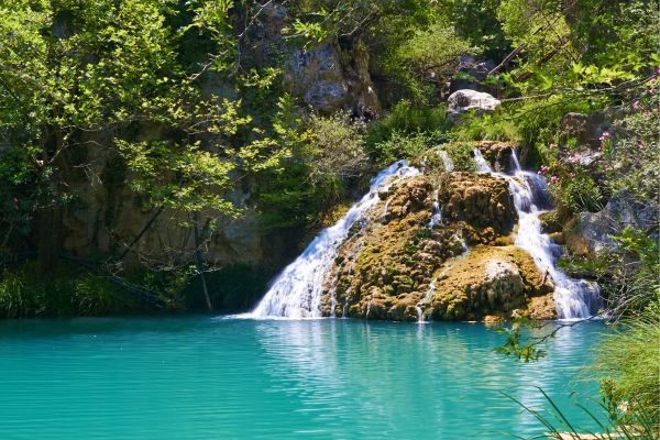 Polilimnio Waterfalls, Messinia: Multi-level waterfalls with natural pools, perfect for swimming and hiking in a lush, scenic setting.